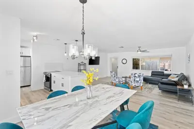 a dining room and living room with a table and chairs at Weekly Discounts 10 min to Beach by TilahStays in Fort Lauderdale
