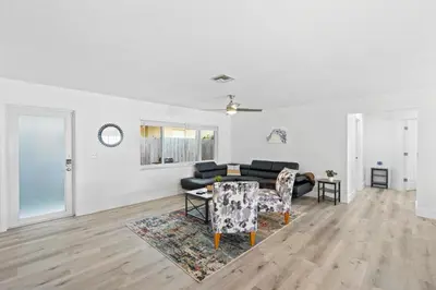 a living room with a couch and a table and chairs at Weekly Discounts 10 min to Beach by TilahStays in Fort Lauderdale