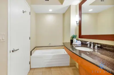 a bathroom with a sink and a bath tub at Deluxe Studio Ocean View Premium Amenities in Sunny Isles Beach