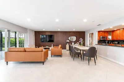 a living room with a couch and a dining room at Waterfront Pool & Amazing Location - WOW in Miami