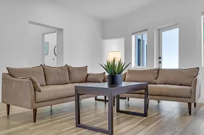 a living room with a couch and a table at Spacious Retreat with Green Areas 8 ppl in Miami