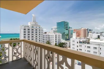 a balcony with a view of the beach and buildings at 1106- 1BR & 1BA with Balcony, Stunning City & Ocean Views in Miami Beach