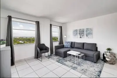 a living room with a couch and a chair at 1106- 1BR & 1BA with Balcony, Stunning City & Ocean Views in Miami Beach