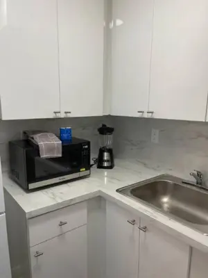 a kitchen counter with a microwave and a sink at 1401- Stylish 1BR& 2BA with Breathtaking Ocean Views in Miami Beach