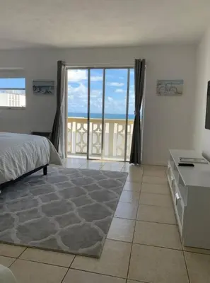 a bedroom with a bed and a view of the ocean at 1402- Oceanfront 1BR & 1 Bath Retreat with Stunning Views in Miami Beach