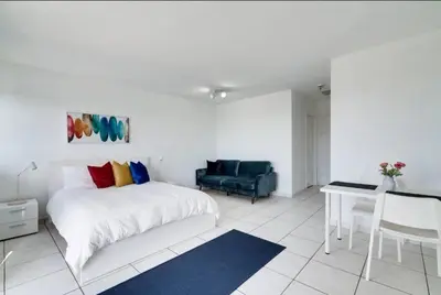 a bedroom with a bed and a desk and a chair at 1405- South Beach 1BR & 1BA- Stunning Ocean View Oasis in Miami Beach