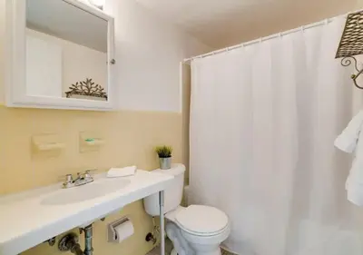 a bathroom with a toilet and a sink and a shower at 1405- South Beach 1BR & 1BA- Stunning Ocean View Oasis in Miami Beach