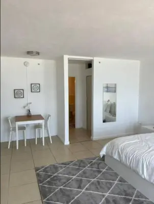 a bedroom with a table and a bed and a table and chairs at 1502- Seaside Serenity- 1BR & 1BA, Ocean Views in Miami Beach