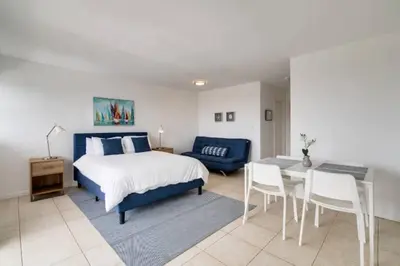 a bedroom with a bed and a table and a couch at 1505- Downtown Miami Bay View Retreat with 1BR & 1BA in Miami Beach