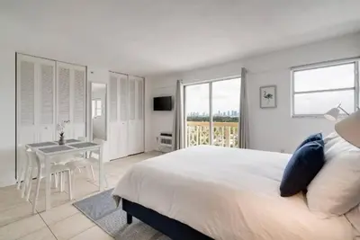 a bedroom with a bed and a table and a desk at 1505- Downtown Miami Bay View Retreat with 1BR & 1BA in Miami Beach