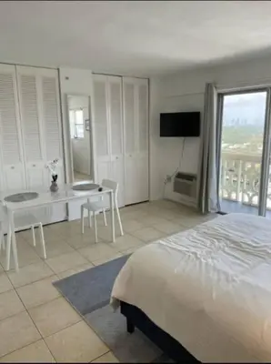 a bedroom with a bed and a table and a television at 1505- Downtown Miami Bay View Retreat with 1BR & 1BA in Miami Beach
