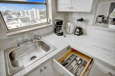 a kitchen counter with a sink and a window at 1506- 1BR & 1BA Retreat with Stunning Intracoastal Views in Miami Beach