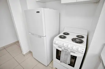 a kitchen with a white stove and a refrigerator at 1506- 1BR & 1BA Retreat with Stunning Intracoastal Views in Miami Beach