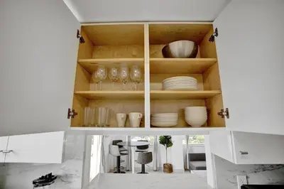 a cabinet with plates and bowls in a kitchen at 1506- 1BR & 1BA Retreat with Stunning Intracoastal Views in Miami Beach