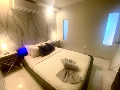 a bedroom with a large bed with a towel on it at Luxurious Waterfront 2 room apartment- Remodeled- Free parking- 5min drive to Miami Beach in Miami Beach