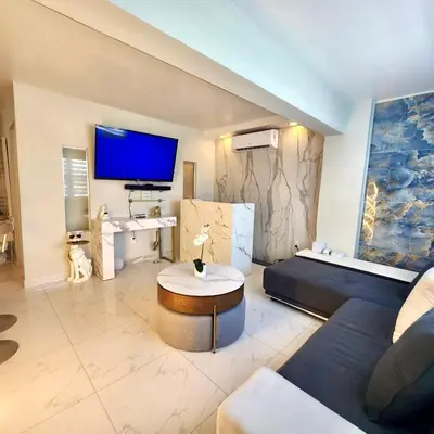 a living room with a couch and a table at Luxurious Waterfront 2 room apartment- Remodeled- Free parking- 5min drive to Miami Beach in Miami Beach