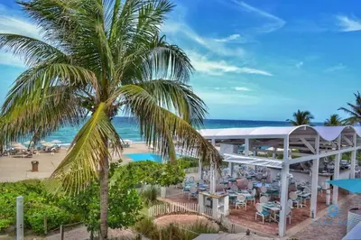 an aerial view of a resort with a palm tree at Luxury Bayfront Studio with Balcony Amazing Pool in Sunny Isles Beach