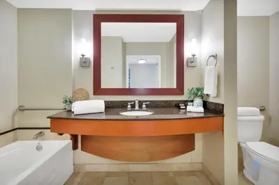 a bathroom with a sink and a mirror at Luxury Bayfront Studio with Balcony Amazing Pool in Sunny Isles Beach