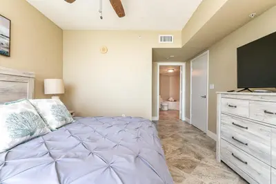 a bedroom with a large bed and a flat screen tv at Beach Vibes & 30th Floor Ocean Views in Sunny Isles Beach