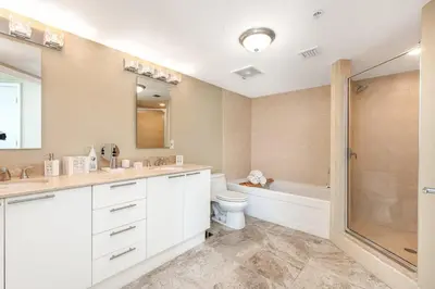a bathroom with a sink and a toilet and a shower at Beach Vibes & 30th Floor Ocean Views in Sunny Isles Beach