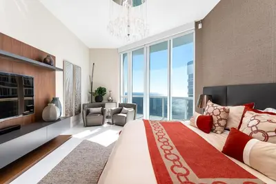 a bedroom with a large bed with a large window at Sophisticated Modern Gem with Unreal Ocean Views in Sunny Isles Beach