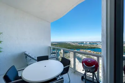 a table and chairs in a room with a balcony at Sophisticated Modern Gem with Unreal Ocean Views in Sunny Isles Beach