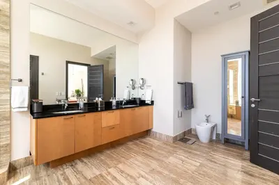 a bathroom with two sinks and a toilet at Sophisticated Modern Gem with Unreal Ocean Views in Sunny Isles Beach