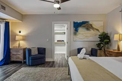 a bedroom with a bed and a blue chair at Luxurious Hollywood Retreat Perfect Getaway in Hollywood