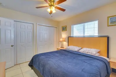 a bedroom with a blue bed and a ceiling fan at Pet-Friendly Hallandale Beach Condo Near Boardwalk in Hallandale Beach
