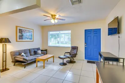 a living room with a couch and a blue door at Pet-Friendly Hallandale Beach Condo Near Boardwalk in Hallandale Beach