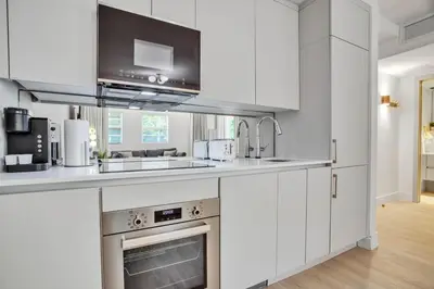 a kitchen with white cabinets and a sink and a stove at Vonder Miami Beach - Unit 3 in Miami Beach