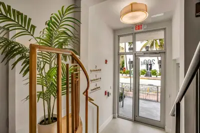 a staircase with a potted plant next to a door at Vonder Miami Beach - Unit 6 in Miami Beach
