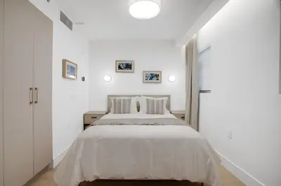 a white bedroom with a large bed with white sheets at Vonder Miami Beach - Unit 7 in Miami Beach