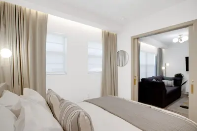 a white bedroom with a bed and a mirror at Vonder Miami Beach - Unit 9 in Miami Beach