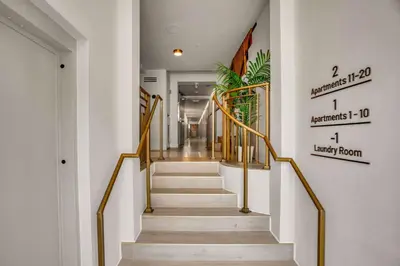 a staircase with gold railings in a hallway at Vonder Miami Beach - Unit 11 in Miami Beach