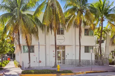 a white building with palm trees in front of it at Vonder Miami Beach - Unit 11 in Miami Beach