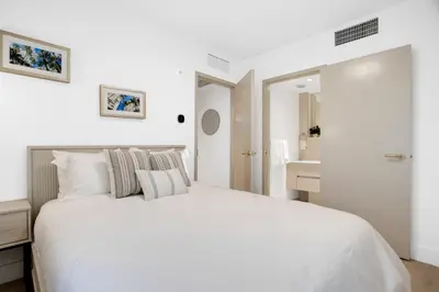 a white bedroom with a large bed and a bathroom at Vonder Miami Beach - Unit 11 in Miami Beach