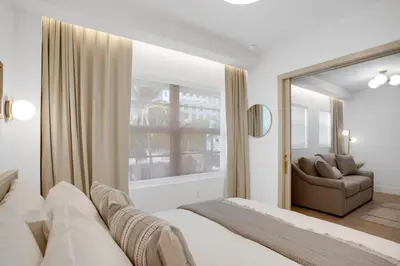a bedroom with a bed and a couch and a window at Vonder Miami Beach - Unit 13 in Miami Beach