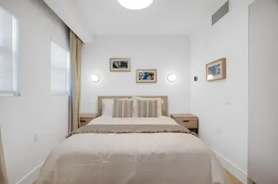 a white bedroom with a large bed and a window at Vonder Miami Beach - Unit 14 in Miami Beach