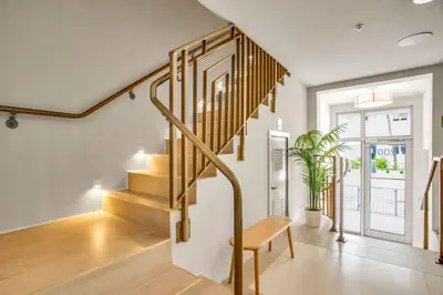 a staircase in a living room with a wooden bench at Vonder Miami Beach - Unit 15 in Miami Beach