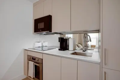 a white kitchen with a sink and a microwave at Vonder Miami Beach - Unit 15 in Miami Beach