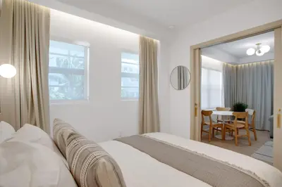 a white bedroom with a bed and a dining room at Vonder Miami Beach - Unit 15 in Miami Beach