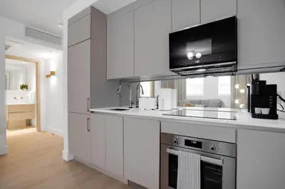 a kitchen with white cabinets and a counter top at Vonder Miami Beach - Unit 18 in Miami Beach
