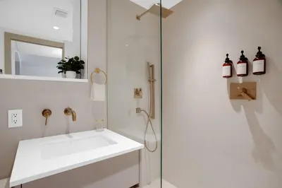 a white bathroom with a sink and a shower at Vonder Miami Beach - Unit 19 in Miami Beach