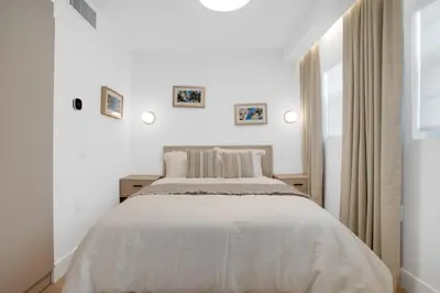 a white bedroom with a bed and a window at Vonder Miami Beach - Unit 19 in Miami Beach