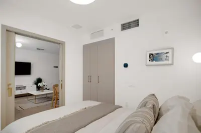 a white bedroom with a bed and a mirror at Vonder Miami Beach - Unit 19 in Miami Beach