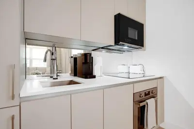 a white kitchen with a sink and a microwave at Vonder Miami Beach - Unit 20 in Miami Beach