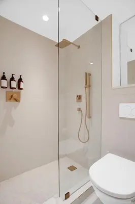 a white bathroom with a shower and a toilet at Vonder Miami Beach - Unit 20 in Miami Beach