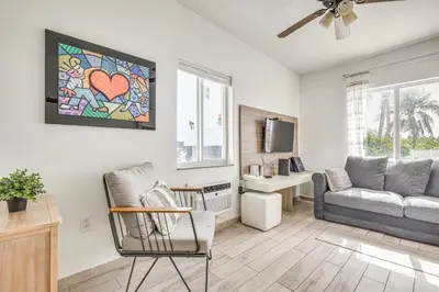 a living room with a couch and a chair at Cozy Miami Beach Apartment Less Than 1 Mi to Ocean! in Miami Beach