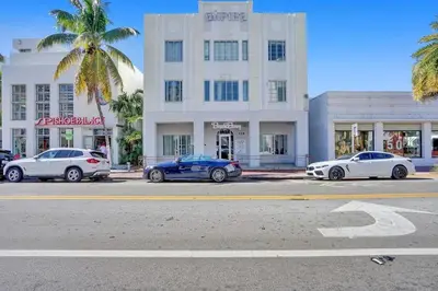 three cars parked in a parking lot in front of a building at Miami Beach Home, 7 guests, Steps from the beach in Miami Beach